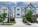 Attractive townhomes featuring two-car garages, stone accents and well maintained lawns at 8415 Zinc Autumn Path, Raleigh, NC 27615