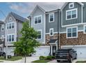 Desirable townhome with a two-car garage, stone accents and mature landscaping at 8415 Zinc Autumn Path, Raleigh, NC 27615