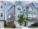 Desirable townhome with a two-car garage and beautiful architectural detailing at 8415 Zinc Autumn Path, Raleigh, NC 27615