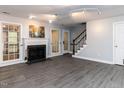 The living room features a fireplace, gray floors, and access to the backyard at 102 Sanair Ct, Apex, NC 27502
