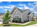 Beautifully landscaped home exterior with stone accents, lush green lawn, and charming architectural details at 1021 Shellbank Dr, Durham, NC 27703