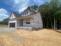 New construction home featuring an attached garage, dormer windows and covered entry at 109 Arundel Dr, Archer Lodge, NC 27527