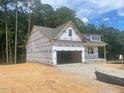 New home featuring a two-car garage, dormer windows, and a covered porch at 109 Arundel Dr, Archer Lodge, NC 27527