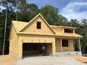 Exterior view of a home under construction, showcasing the raw framing and initial structure at 109 Arundel Dr, Archer Lodge, NC 27527