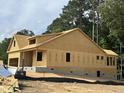 Exterior view of a home under construction, featuring exposed framing and structural details at 109 Arundel Dr, Archer Lodge, NC 27527