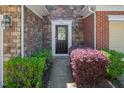 Inviting front entrance with stone accents, beautiful landscaping, and stylish exterior lighting at 1116 Kingston Grove Drive Dr, Cary, NC 27519