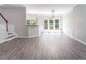 Bright living room featuring fresh paint, new floors, and many windows offering natural light at 1116 Kingston Grove Drive Dr, Cary, NC 27519