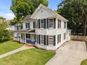 Beautiful two-story home with classic architectural details, lush lawn, and long driveway at 112 Rectory St, Oxford, NC 27565