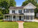 Inviting two-story home featuring a spacious front porch and lush green lawn at 112 Rectory St, Oxford, NC 27565