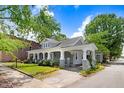 Inviting home exterior featuring a classic covered porch, manicured lawn, and blossoming flowers adding to its curb appeal at 125 W Pine St, Pine Level, NC 27568