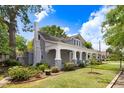 Charming home with a lush, green lawn, manicured landscaping, and a welcoming front porch featuring decorative columns at 125 W Pine St, Pine Level, NC 27568