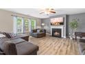 Cozy living room featuring a fireplace, large windows, and stylish, neutral decor at 2011 Unbridled Dr, Knightdale, NC 27545