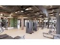 On-site gym with mirrored walls, ceiling fans, weight machines and plenty of floor space at 2201 W Cornwallis Rd, Durham, NC 27705