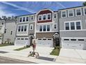 View of new construction townhomes featuring attached garages and neutral toned exteriors at 2203 Lambert Rd # 67, Cary, NC 27519