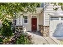 Inviting front porch with stone pillars and a red door, offering a warm welcome at 226 Begen St, Morrisville, NC 27560