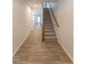 Inviting entryway with durable hardwood flooring and a staircase leading to the upper level at 227 Liam St, Clayton, NC 27520