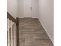 Upstairs hallway with hardwood flooring and a white front door at 227 Liam St, Clayton, NC 27520