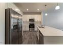 Modern kitchen with stainless steel appliances, white cabinetry, and a center island at 227 Liam St, Clayton, NC 27520