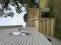 A new, unfinished backyard deck and stairs against a home with white siding and mature trees at 2309 Pinecroft Dr, Burlington, NC 27217
