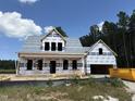 New construction home with a covered porch and modern architectural details is ready to be customized at 239 Pretty Run Branch Ln, Wendell, NC 27591