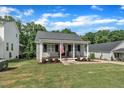 Lovely single-Gathering home with a covered front porch, swing and nicely landscaped front yard at 267 Ashley Woods Ct, Clayton, NC 27527