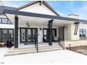 Inviting clubhouse entrance with a covered porch, black accents, and stone detailing at 287 Aspen Ave, Pittsboro, NC 27312
