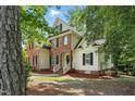 An attractive two-story home featuring brick and siding, complemented by well-maintained landscaping at 3020 Woods Walk Way, Rocky Mount, NC 27804