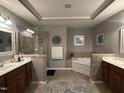 Bathroom featuring double vanity sinks, a corner soaking tub, and a glass shower at 3041 Weston Green Loop, Cary, NC 27513