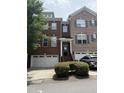 Two-story townhome with brick facade, integrated garage, and a well-maintained landscaped front yard at 3041 Weston Green Loop, Cary, NC 27513