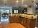Kitchen with granite countertops, stainless steel dishwasher, and adjacent living spaces at 3041 Weston Green Loop, Cary, NC 27513