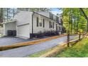 Traditional home featuring an attached garage with black shutters and mature landscaping at 3070 Cameron Dr, Henderson, NC 27536