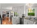 Bright kitchen features white cabinetry, granite countertops, stainless steel appliances, and hardwood flooring at 3070 Cameron Dr, Henderson, NC 27536