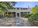 Two-story condo featuring brick and siding, with a walkway leading to the entrance at 3427 Mill Run, Raleigh, NC 27612