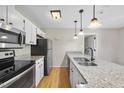 Modern kitchen with stainless steel appliances and granite countertops at 3427 Mill Run, Raleigh, NC 27612