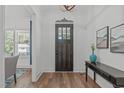 Stylish entryway featuring hardwood floors, a dark wood door with glass panes, and tasteful decor at 415 1St St, Apex, NC 27502