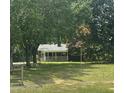 Cozy brick home surrounded by mature trees, providing shade and privacy at 4796 Covered Bridge Rd, Archer Lodge, NC 27527