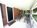 Covered front porch featuring seating, brick exterior, and a 'Welcome' mat at 4796 Covered Bridge Rd, Archer Lodge, NC 27527
