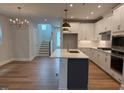 The kitchen island features modern pendant lighting and beautiful countertops at 64 Rainfall Dr, Pittsboro, NC 27312