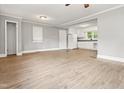 The bright, open floor plan living room features new floors and creates an inviting flow into the kitchen area at 7924 Knightdale Blvd, Knightdale, NC 27545