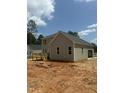 Rear exterior of the home showcases gray siding, a wooden deck with railing, and an attached garage with an open door at 80 Copper Penny Rd, Zebulon, NC 27597