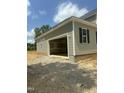 Spacious detached garage featuring an open layout with work bench, light gray siding, and a concrete foundation at 80 Copper Penny Rd, Zebulon, NC 27597