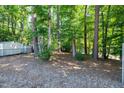 Backyard featuring a wooded area with mature trees providing privacy and shade at 100 Honeysuckle Ln, Cary, NC 27513