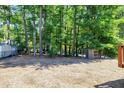 Backyard featuring a wooded area with mature trees providing privacy and shade at 100 Honeysuckle Ln, Cary, NC 27513