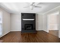 Open living room with dark brick fireplace and bright white trim at 100 Honeysuckle Ln, Cary, NC 27513