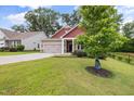 Charming exterior with a well-maintained lawn, and an attached two-car garage at 100 Pronghorn Deer Ct, Garner, NC 27529