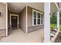 Welcoming covered front porch with stone accents and a view of the home's exterior at 100 Pronghorn Deer Ct, Garner, NC 27529