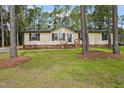Charming home with a manicured lawn and surrounded by mature trees at 101 Hunter Fld, Sanford, NC 27332