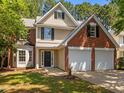 Charming two-story home features a two-car garage, brick accents, and a well-manicured lawn at 103 Burham Ct, Apex, NC 27502