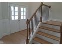 Inviting entryway with wood stairs and black iron railing, leading to the home's interior at 1042 Tulloch Court Ct # 213, Burlington, NC 27215