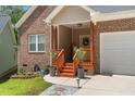 Charming brick home with covered front entrance, flower boxes, and a well-manicured lawn at 1051 Upland Reach, Sanford, NC 27332